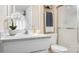 Bright bathroom features a vanity with a speckled countertop and a glass-enclosed shower, offering a clean and functional space at 8326 Ramath Dr, Charlotte, NC 28211
