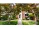 Charming brick home with inviting walkway, lush landscaping, and a pristine white front door at 8326 Ramath Dr, Charlotte, NC 28211