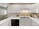 Kitchen featuring white cabinets, stainless steel sink, tile backsplash, and white countertops at 8326 Ramath Dr, Charlotte, NC 28211