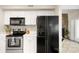 Kitchen featuring white cabinets, black appliances, white countertops, and tiled floors at 8326 Ramath Dr, Charlotte, NC 28211
