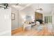 Open living area with hardwood floors, stone fireplace, and ample natural light at 8326 Ramath Dr, Charlotte, NC 28211
