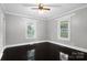 Bright bedroom with hardwood floors, complemented by natural light from two windows, offering a peaceful ambiance at 872 Wellman St, Gastonia, NC 28054