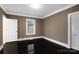 Cozy bedroom with dark hardwood floors, window bringing in light, and closet with a paneled door at 872 Wellman St, Gastonia, NC 28054
