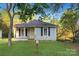 Charming single-story home with a well-maintained lawn and inviting front porch framed by mature trees at 872 Wellman St, Gastonia, NC 28054