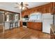 Well-lit kitchen with wood cabinets, and modern appliances, complemented by hardwood floors and a ceiling fan at 872 Wellman St, Gastonia, NC 28054