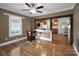 Inviting living room with hardwood floors, ceiling fan, and an open view to the kitchen and natural light from the window at 872 Wellman St, Gastonia, NC 28054