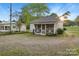 View of shed/cottage featuring a screened-in porch with 'X' style framing and mature trees at 872 Wellman St, Gastonia, NC 28054
