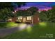 Beautiful brick home with manicured lawn at dusk, featuring inviting exterior lighting and a serene ambiance at 1053 Stoneybrook Ln, Rock Hill, SC 29730