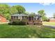 Charming single-story brick home with a well-maintained lawn and mature landscaping, exuding curb appeal at 1053 Stoneybrook Ln, Rock Hill, SC 29730