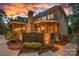 Backyard view of the property showcasing the outdoor kitchen, lighting and patio at 1102 Anniston Pl, Wesley Chapel, NC 28079