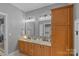 Bright bathroom with double vanity, granite countertops, decorative mirrors, and ample cabinet space for modern living at 1102 Anniston Pl, Wesley Chapel, NC 28079