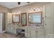 A luxurious bathroom includes dual vanities and a makeup area, combining style and functionality at 1102 Anniston Pl, Wesley Chapel, NC 28079
