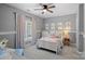 Charming bedroom with soft pink accents, plush bedding, and natural light for a serene and inviting atmosphere at 1102 Anniston Pl, Wesley Chapel, NC 28079