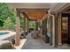 A covered patio featuring wood ceilings, ceiling fans, and an outdoor dining set at 1102 Anniston Pl, Wesley Chapel, NC 28079