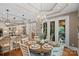 An inviting dining area with an elegant chandelier and decorative table setting are ready for entertaining at 1102 Anniston Pl, Wesley Chapel, NC 28079