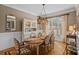 Charming dining room with hardwood floors, a rustic table, and a hutch for storage at 1102 Anniston Pl, Wesley Chapel, NC 28079