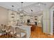 A spacious kitchen featuring granite countertops, double islands, and pendant lighting exudes luxury at 1102 Anniston Pl, Wesley Chapel, NC 28079