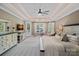 A luxurious main bedroom suite boasts a trey ceiling and a cozy seating area by the windows at 1102 Anniston Pl, Wesley Chapel, NC 28079