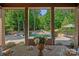 A dining room view overlooks the backyard featuring a swimming pool with slide and jacuzzi at 1102 Anniston Pl, Wesley Chapel, NC 28079