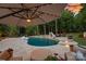 Inviting backyard pool with two water slides, spa, and outdoor seating area, perfect for entertaining at 1102 Anniston Pl, Wesley Chapel, NC 28079