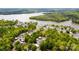 Aerial view showcases the community near the lake and surrounding woods at 127 Hummingbird Cir, New London, NC 28127
