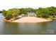 Aerial view of the sandy beach area, perfect for relaxing and swimming at 127 Hummingbird Cir, New London, NC 28127