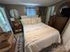 Comfortable bedroom with cozy rug, decorative mirror, dresser and a large window with natural light at 127 Hummingbird Cir, New London, NC 28127