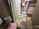 Small bedroom with single bed with colorful bedding and adjacent closet at 127 Hummingbird Cir, New London, NC 28127