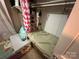 Small bedroom with single bed with colorful bedding and adjacent closet with flamingo shower curtain at 127 Hummingbird Cir, New London, NC 28127