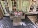 Relaxing covered deck seating area with stylish outdoor furniture at 127 Hummingbird Cir, New London, NC 28127