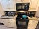 Updated kitchen features stainless steel appliances, tile backsplash and ample cabinet storage space at 127 Hummingbird Cir, New London, NC 28127