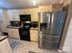 Kitchen featuring stainless appliances, neutral cabinets and tile floors at 127 Hummingbird Cir, New London, NC 28127