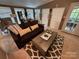 Cozy living room with a dark sofa, decorative rug, and bright natural light at 127 Hummingbird Cir, New London, NC 28127