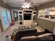 Relaxing living area, neutral tones, with a tv, couch, and a view into the kitchen at 127 Hummingbird Cir, New London, NC 28127