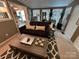 Stylish living room with neutral carpet, dark sofa, coffee table, and stylish accents at 127 Hummingbird Cir, New London, NC 28127