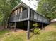 Rear exterior view of the home featuring a screened porch and deck at 127 Hummingbird Cir, New London, NC 28127