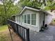 Home exterior featuring a gray wood deck, matching railings, and vinyl siding at 127 Hummingbird Cir, New London, NC 28127