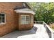 Spacious wooden back deck with a brick exterior and white trim windows overlooking the wooded backyard at 1468 Woodhurst Dr, Rock Hill, SC 29732