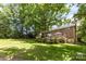 Manicured lawn on a large lot with mature trees and a brick home in the background at 1468 Woodhurst Dr, Rock Hill, SC 29732