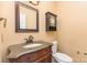 Cozy powder room featuring a granite vanity and decorative mirror and cabinet at 1468 Woodhurst Dr, Rock Hill, SC 29732