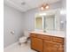 Bathroom with single vanity, tile floor, and a toilet at 1468 Woodhurst Dr, Rock Hill, SC 29732