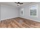 Bright bedroom featuring neutral walls, wood flooring, and natural light at 1468 Woodhurst Dr, Rock Hill, SC 29732