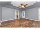 Spacious bedroom features a ceiling fan, ensuite bath, and wood flooring at 1468 Woodhurst Dr, Rock Hill, SC 29732