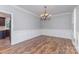 Elegant dining room with hardwood floors, wainscoting, crown molding, and a decorative chandelier at 1468 Woodhurst Dr, Rock Hill, SC 29732