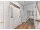 Welcoming entryway featuring a wood floor, white trim, and a stylish white door with decorative shutters at 1468 Woodhurst Dr, Rock Hill, SC 29732