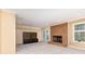 Cozy living room with brick fireplace, carpet flooring, and natural light at 1468 Woodhurst Dr, Rock Hill, SC 29732