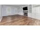 Open living room with hardwood floors, a white fireplace, and built-in bookshelves at 1468 Woodhurst Dr, Rock Hill, SC 29732