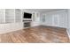 Spacious living room featuring built-in bookshelves, a fireplace, and hardwood floors at 1468 Woodhurst Dr, Rock Hill, SC 29732