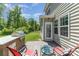 Comfortable outdoor patio with grill, chairs, and an inviting space for relaxation and entertaining at 1552 Trentwood Dr, Fort Mill, SC 29715