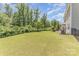 Large grassy backyard featuring a fence line, perfect for outdoor enjoyment and privacy at 1552 Trentwood Dr, Fort Mill, SC 29715
